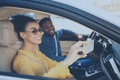 Young man and woman in a new car