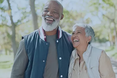 Older couple on a walk smiling